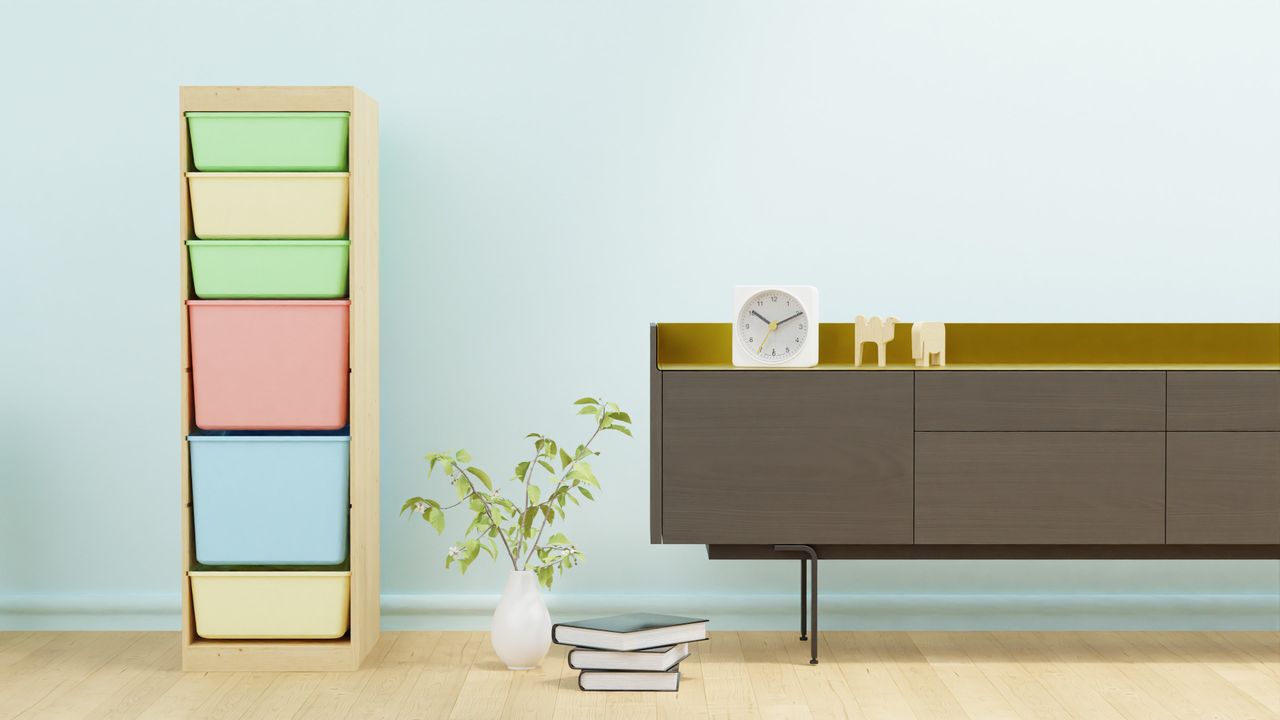 Minimalist room with colorful storage bins, sleek cabinet, and a clock for modern interior design.